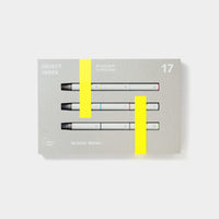 A set of three white modular marker pens in rectangular grey packaging with neon yellow accents.