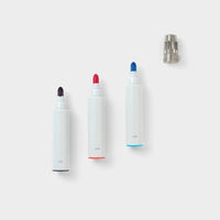 The tips of three white modular marker pens in black, red and blue.