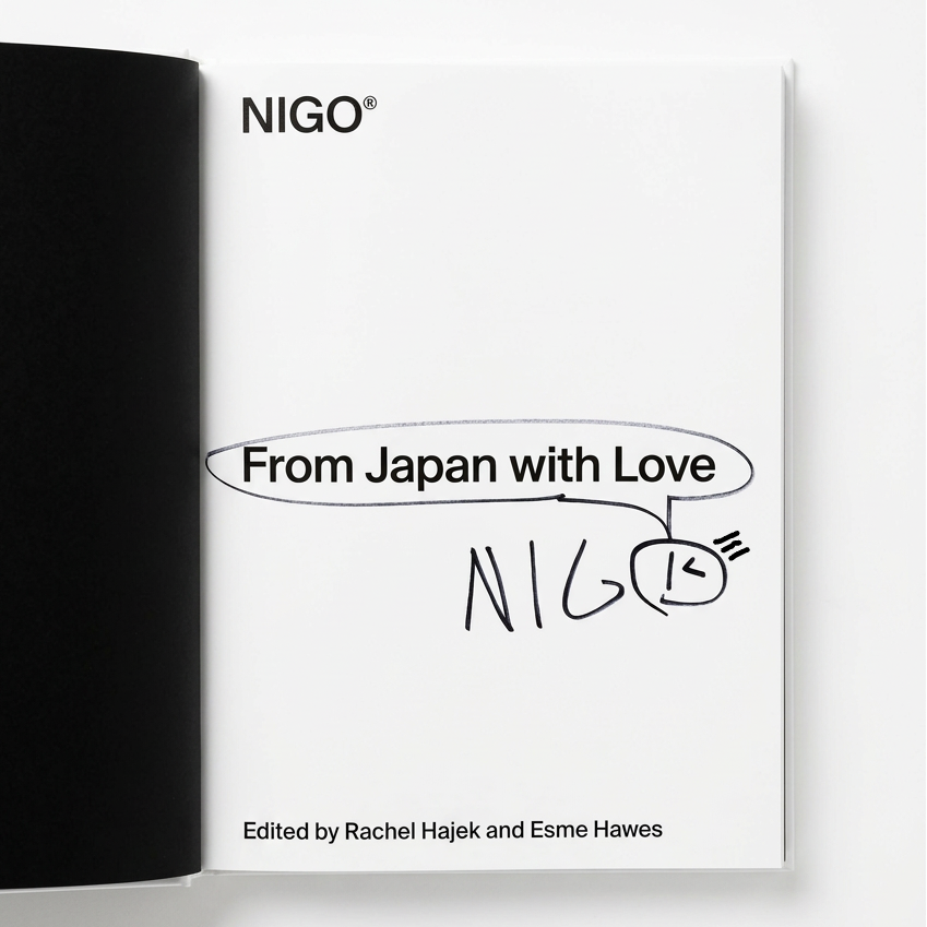 An open book or booklet showing a white interior page with the title 'From Japan with Love' and 'NIGO' printed in black, alongside a black cover edge on the left, photographed against a light gray background.