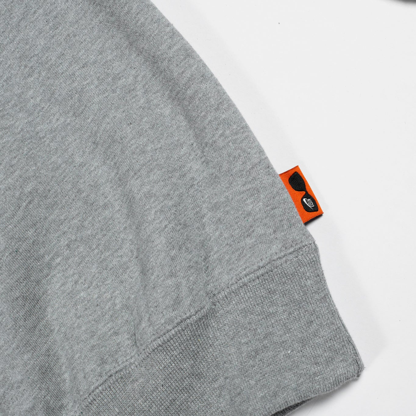 Gray sweatshirt with a brand tag on a white background