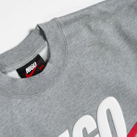 Gray sweatshirt with a brand label on a light gray background