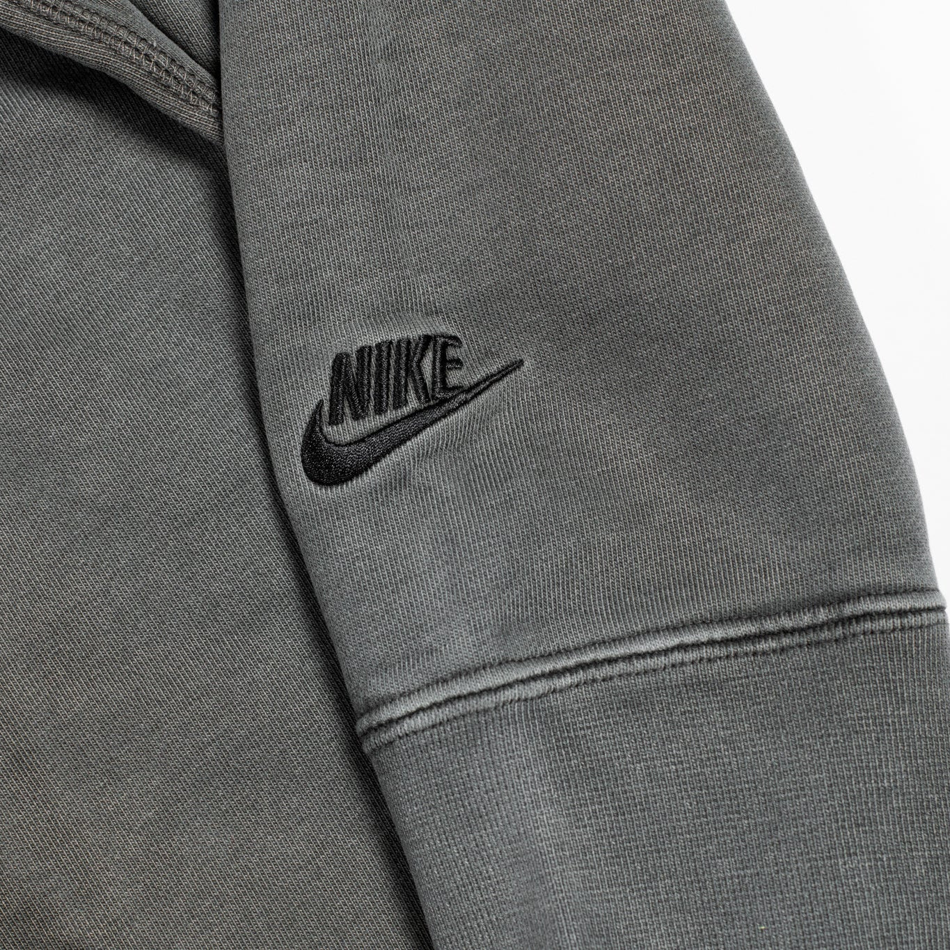 Gray Nike jacket with logo on a light gray background