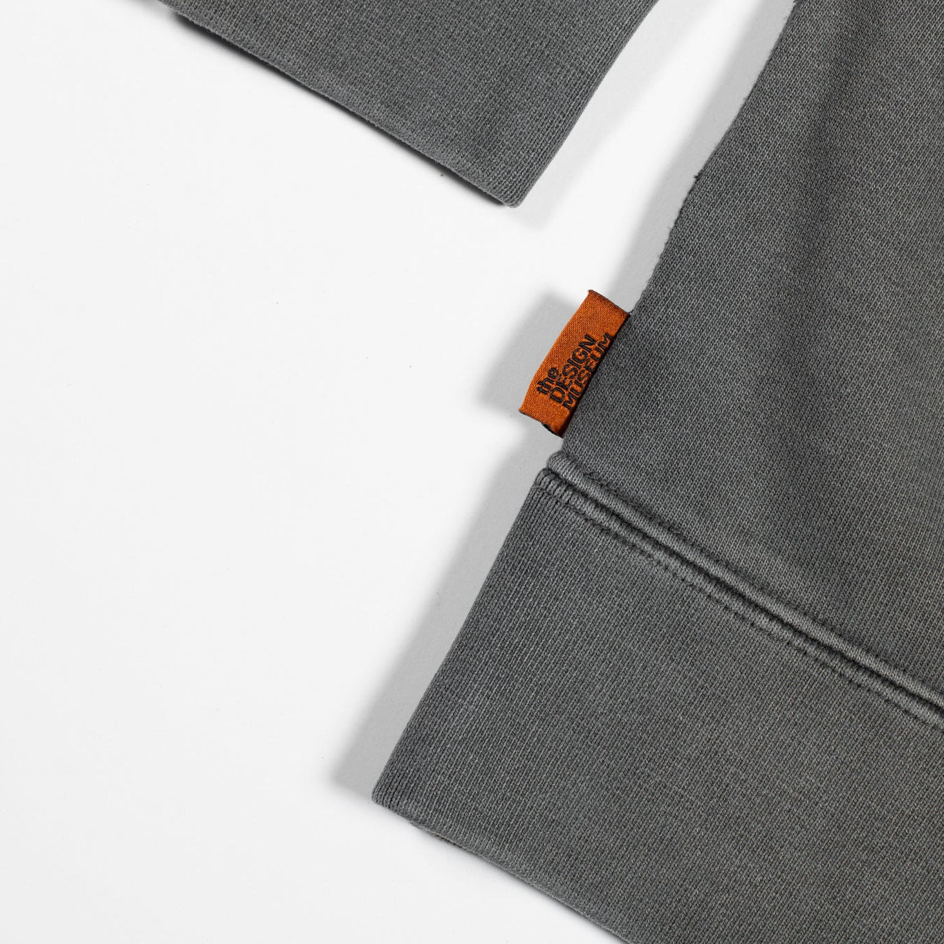 Gray fabric with a brand tag on a white background