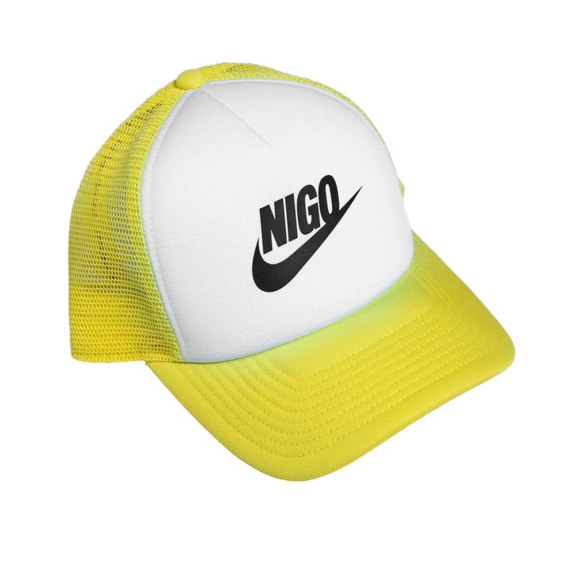 Yellow and white cap with 'NIGO' logo on a light gray background