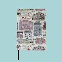 Notebook with a colorful cityscape design on the cover against a white background