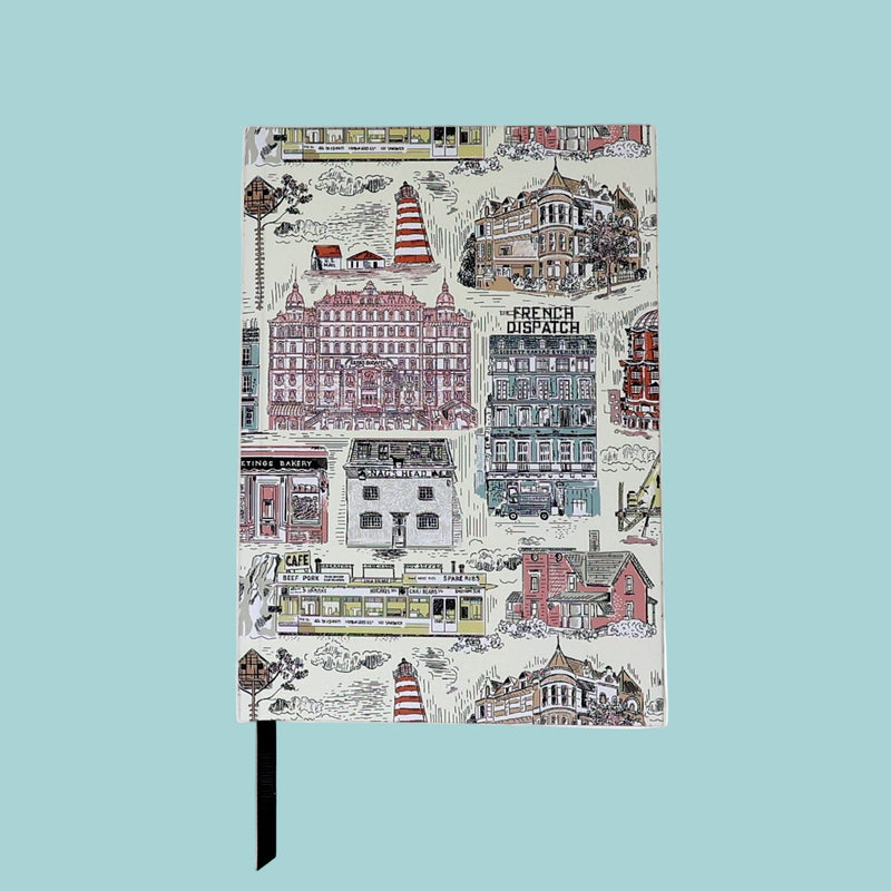 Notebook with a colorful cityscape design on the cover against a white background