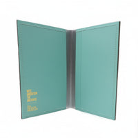 Teal passport holder with visible branding on a white background