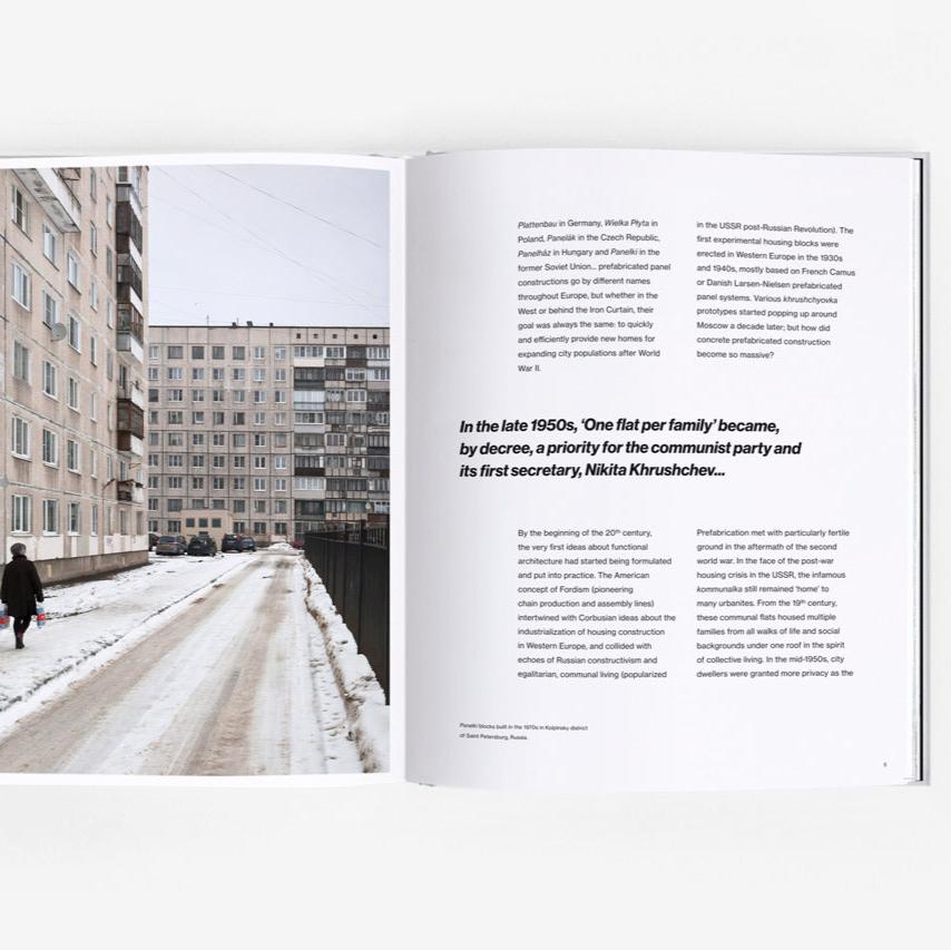 Open page of Panelki book featuring a photograph of a brutalist building and a page with text.