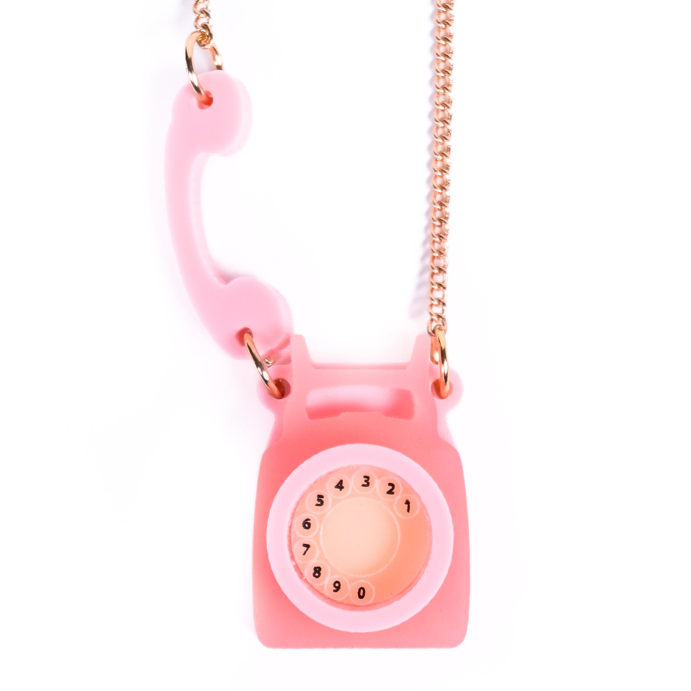 Pink phone-shaped necklace with a chain on a white background