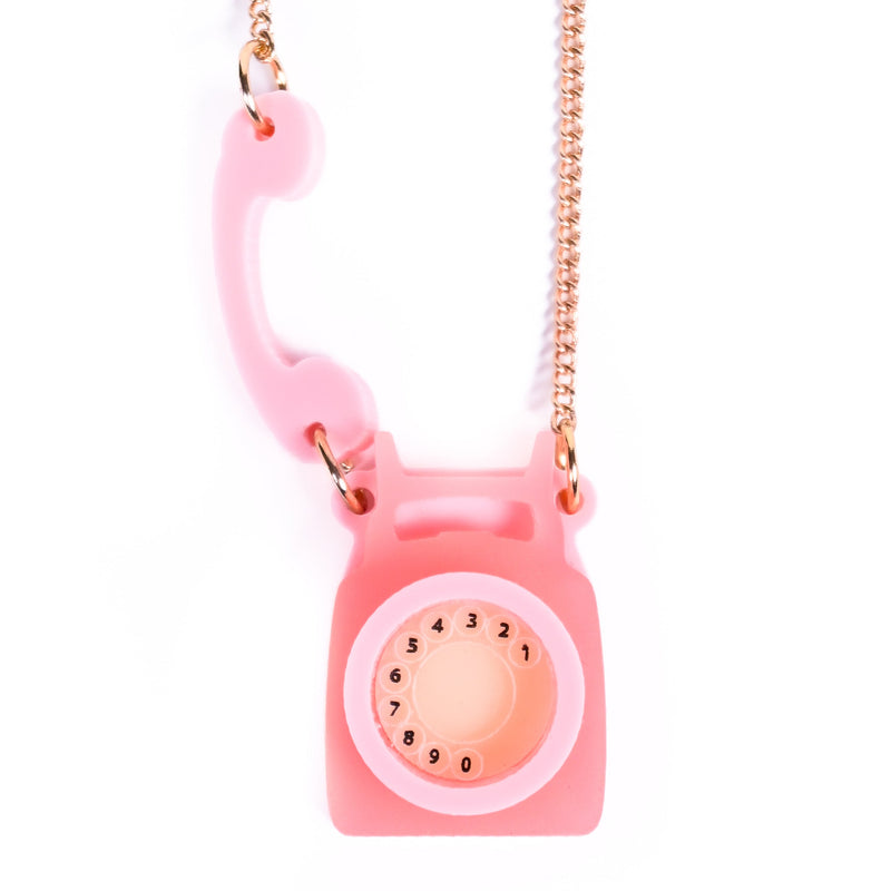 Pink phone-shaped necklace with a chain on a white background