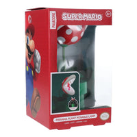 Super Mario Piranha Plant Posable Lamp in its original red and white packaging, featuring Mario graphics and a clear window showing the lamp inside.