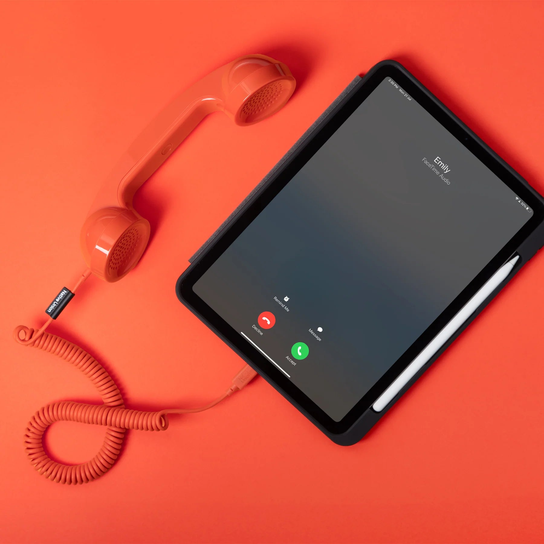 Tablet with a phone app interface on an orange background