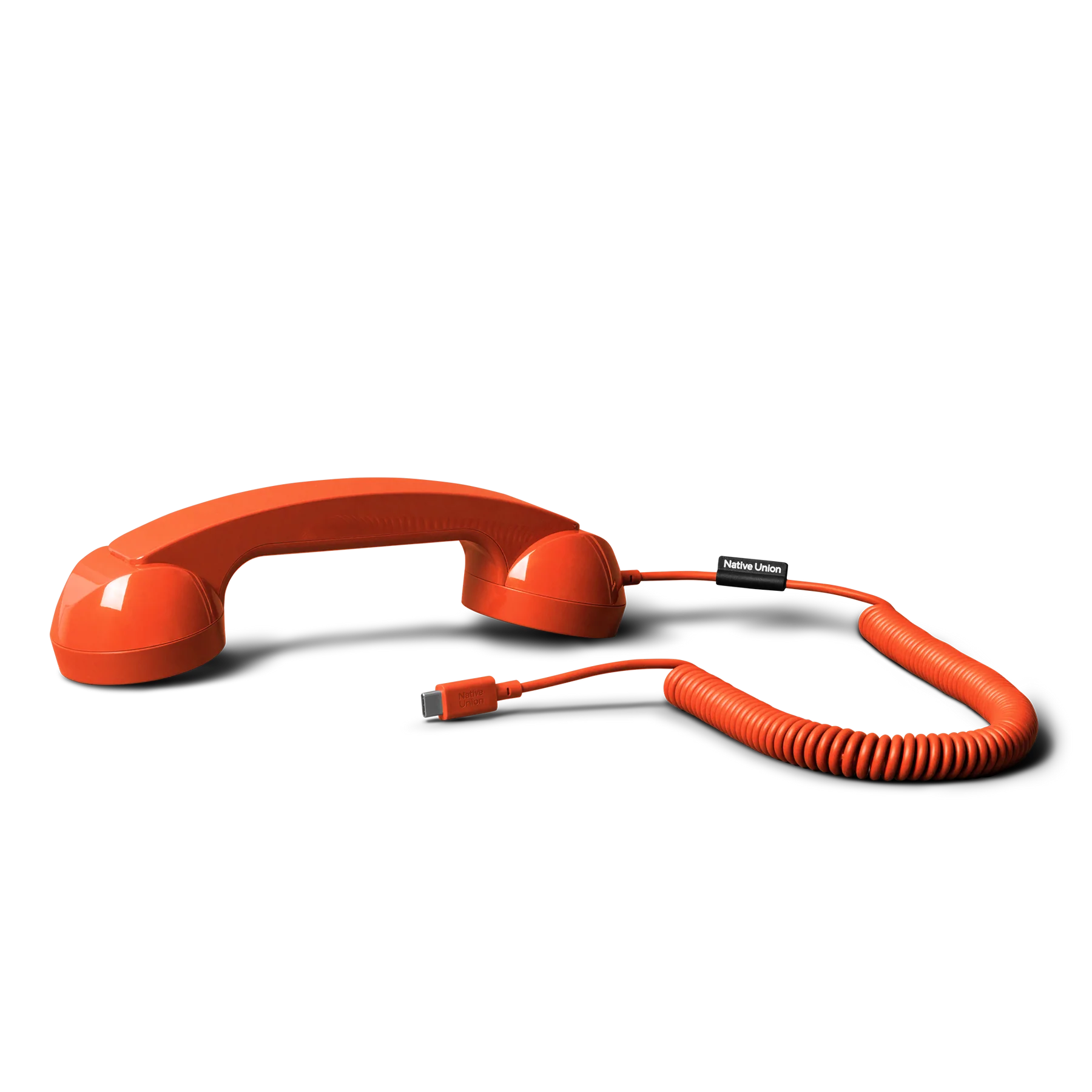 Orange telephone handset with coiled cord on a white background