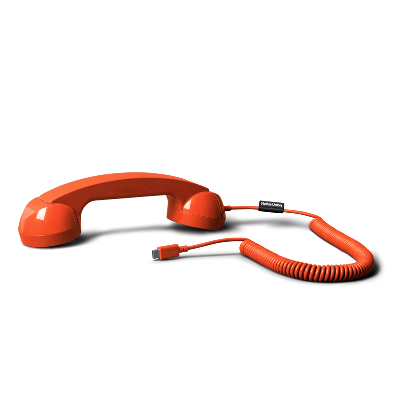 Orange telephone handset with coiled cord on a white background