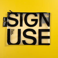 A rectangular translucent black and white pouch with the words 'SIGN USE' printed in large black letters, shown against a solid bright yellow background.
