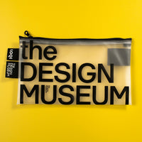 A clear zippered pouch with black text reading 'the DESIGN MUSEUM' on a bright yellow background. A black fabric tag on the left side shows the brand 'tooy'.