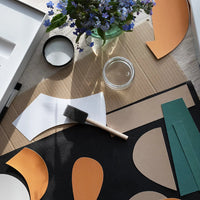 Decorative table setting with abstract paper collage cut out shapes and flowers