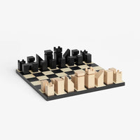 A minimalist wooden chess set on a light gray background. 