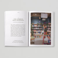 Open page of Queer London book featuring a photograph of the Common Press Bookshop.