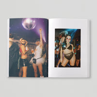 Open page of Queer London book featuring a photograph of people dancing under a disco ball.