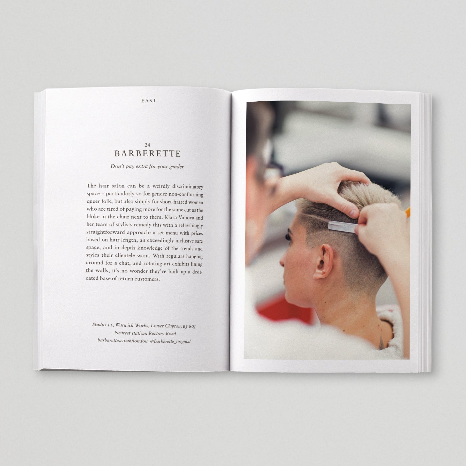Open page of Queer London book featuring a photograph of a person getting a haircut.