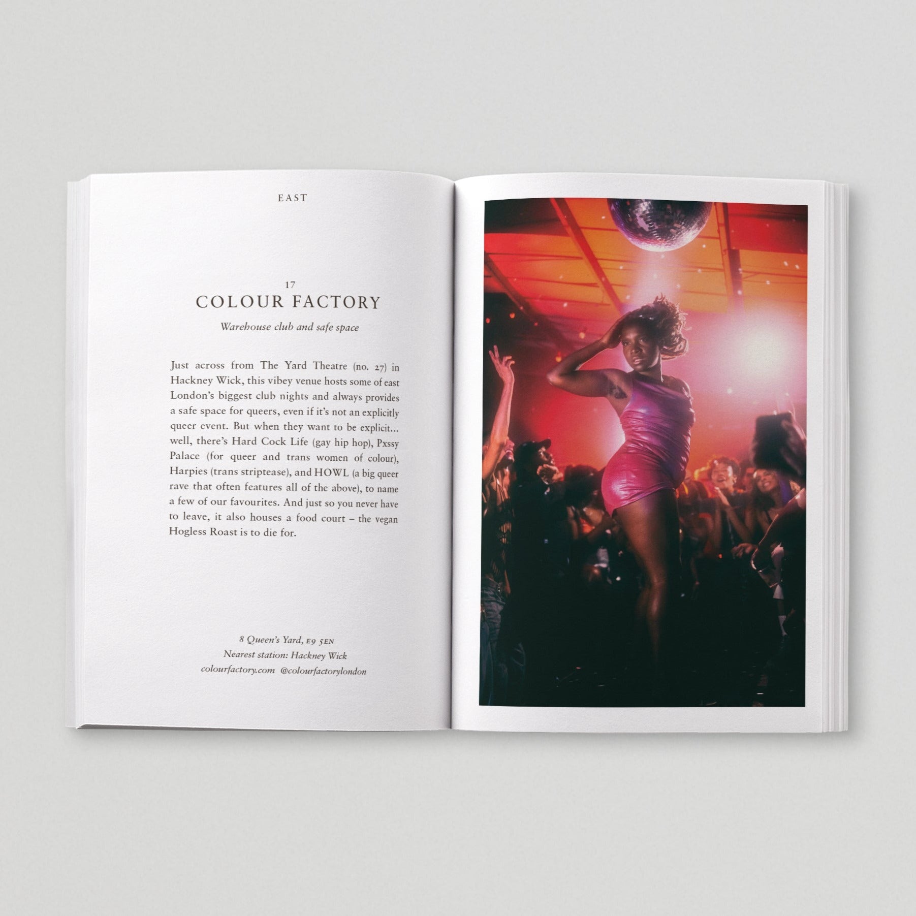 Open page of Queer London book featuring a photograph of a person dancing on a stage amongst a crowd of people underneath a disco ball. 