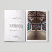 Open page of Queer London book featuring a photograph of the interior of the Gilbert & George Centre. 