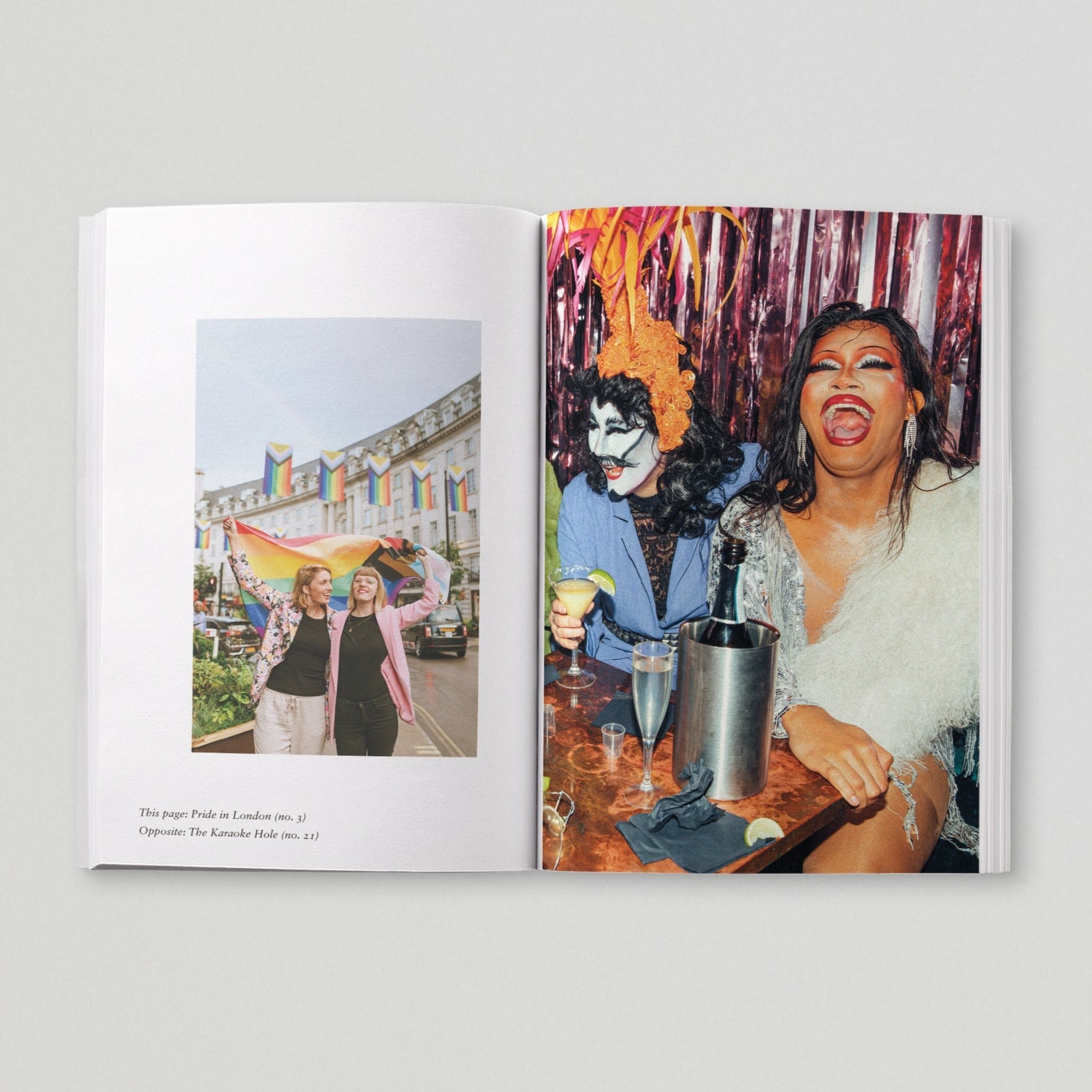 Open page of Queer London book featuring a photograph of people holding a rainbow pride flag and two people at a bar.