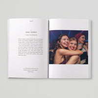 Open page of Queer London book featuring a photograph of two people embracing in a nightclub.