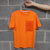 Orange t shirt on a brick wall background