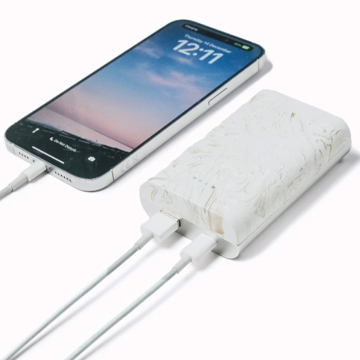 White power bank charging a phone