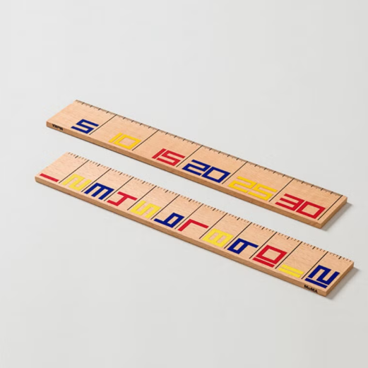 Two wooden number rulers with colorful numbers on a light gray background