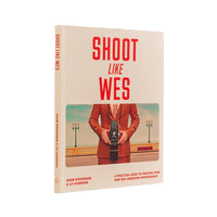 Book cover of 'Shoot Like Wes' with a person holding a camera on a beige background
