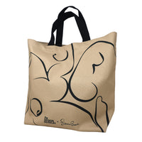 Beige tote bag with black abstract design on a white surface