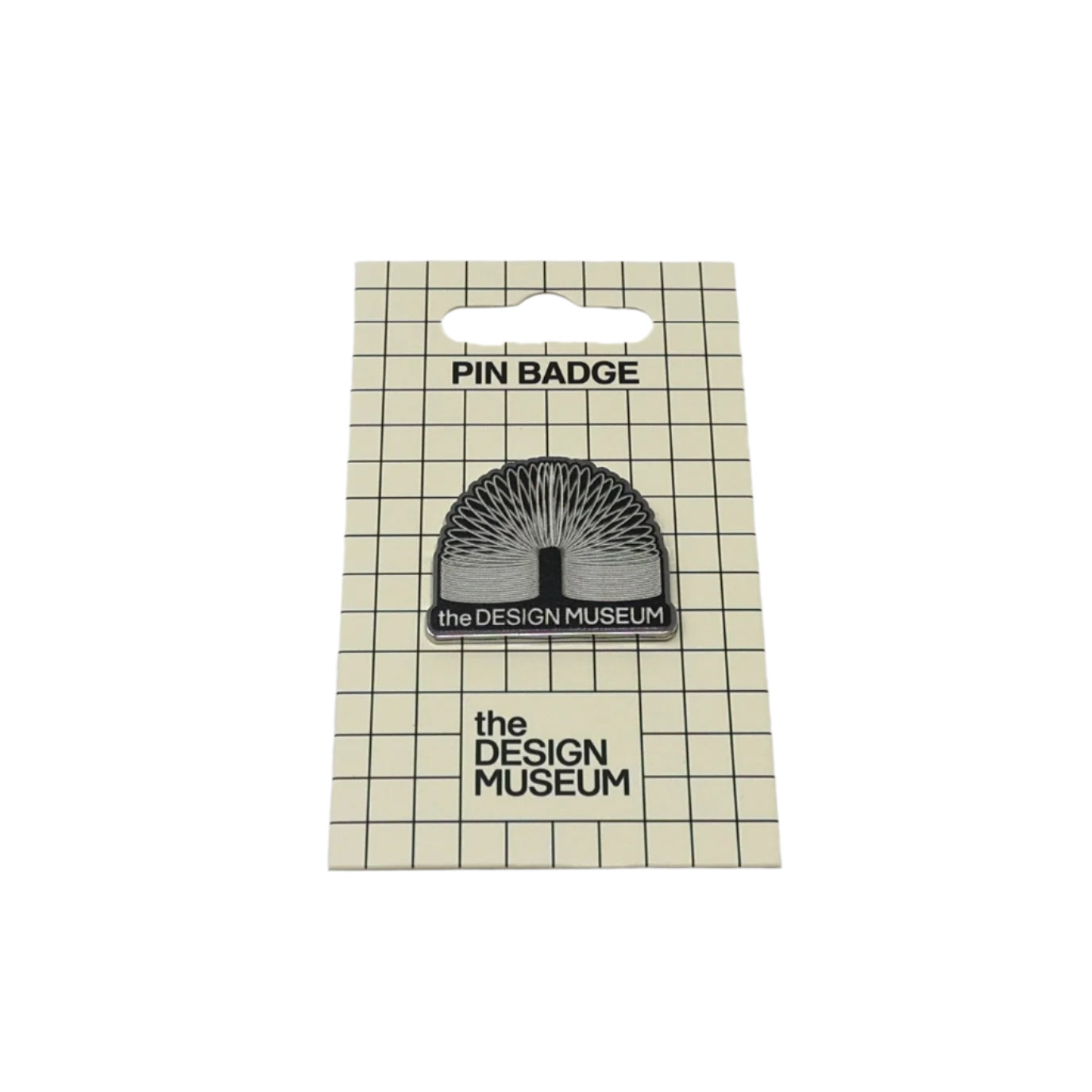 A slinky pin badge on checkered card packaging