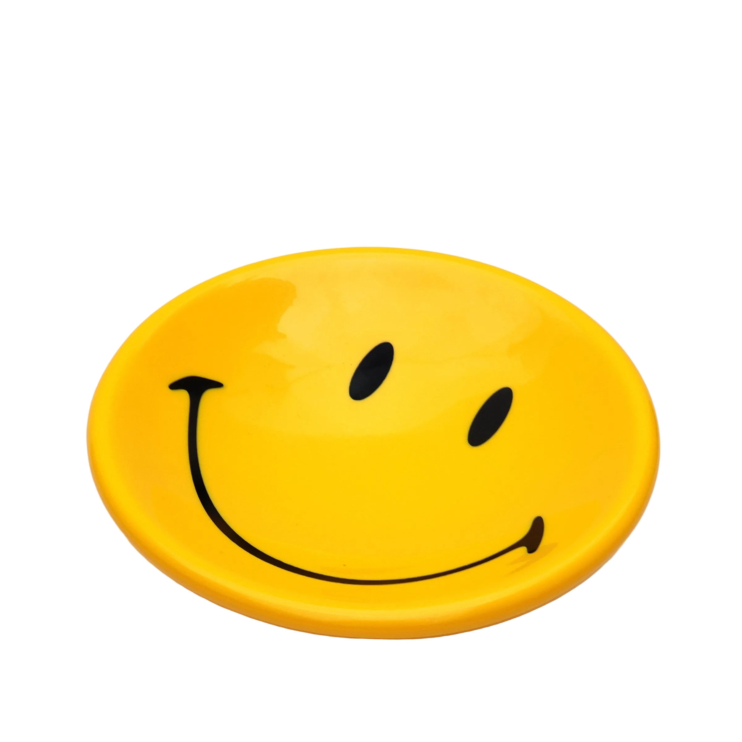 Yellow plate with a smiley face design on a white background