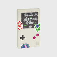 A packaging box for 'Game Over' socks in the shape of a games console with colourful stickers on top.