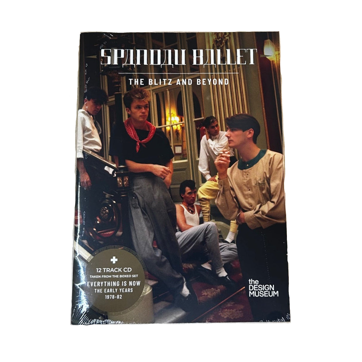 CD cover with people sitting on a couch, placed on a wooden surface.