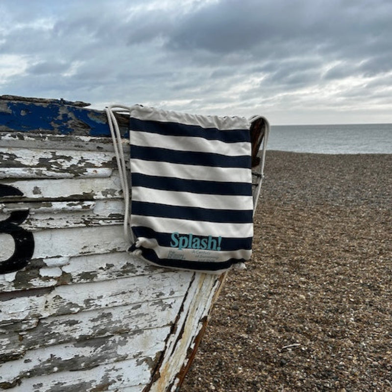 lifestyle picture of Splash! Bag on boat by pebbly beach, cloud day