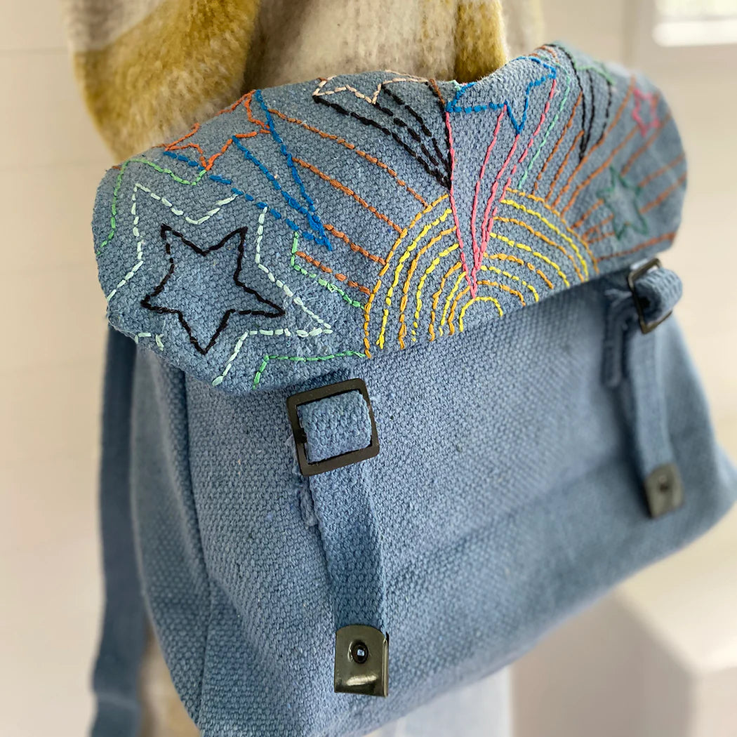 A blue satchel embroidered with colourful stars design.