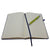 Image of the Design Museum Branded A5 size notebook, open page photo of notebook with a pen when it shows that notebook has lined white paper.