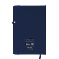 Back cover image of the Design Museum Branded A5 size notebook, the notebook back is navy blue plain, there its found some information about where it is manufactured and features small design museum logo.