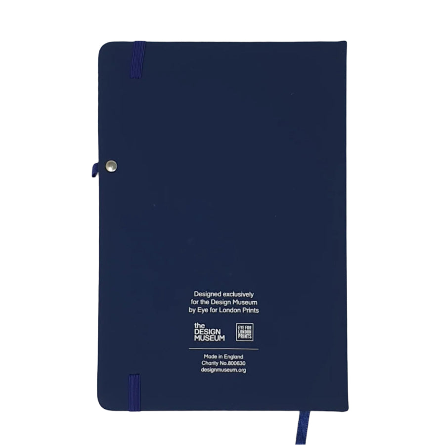 Back cover image of the Design Museum Branded A5 size notebook, the notebook back is navy blue plain, there its found some information about where it is manufactured and features small design museum logo.