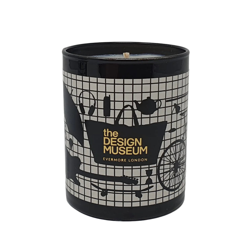 A black scented candle with a black grid design featuring black silhouttes of objects with the Design Museum branding.