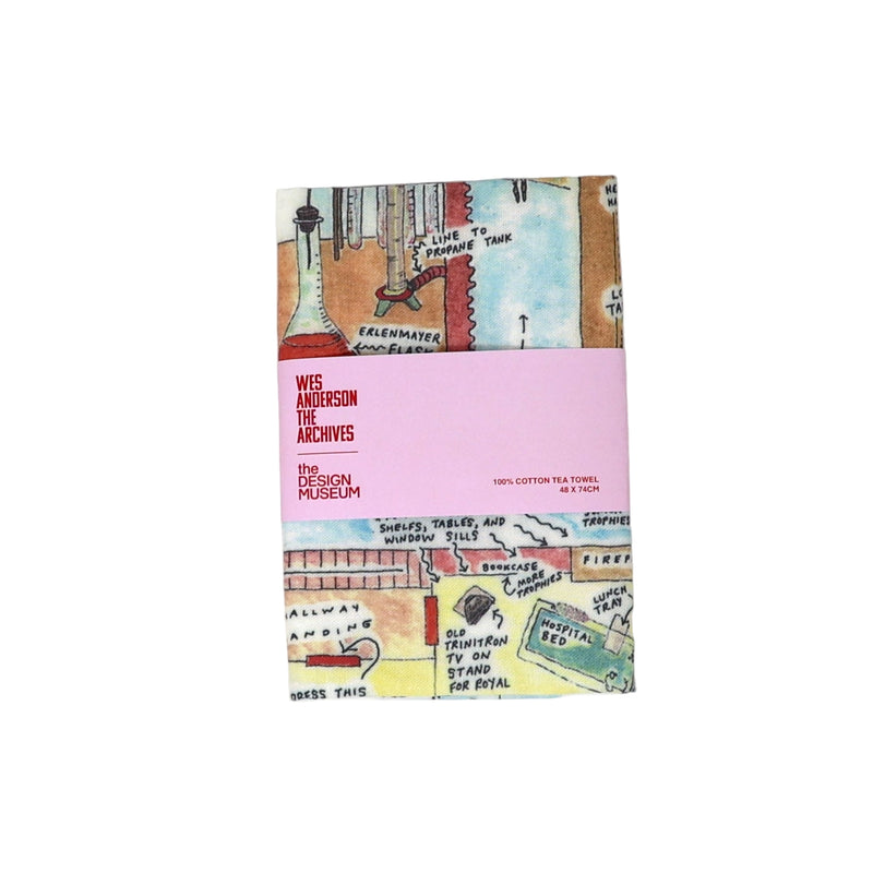 Tea towel with colorful design and pink label on a white background