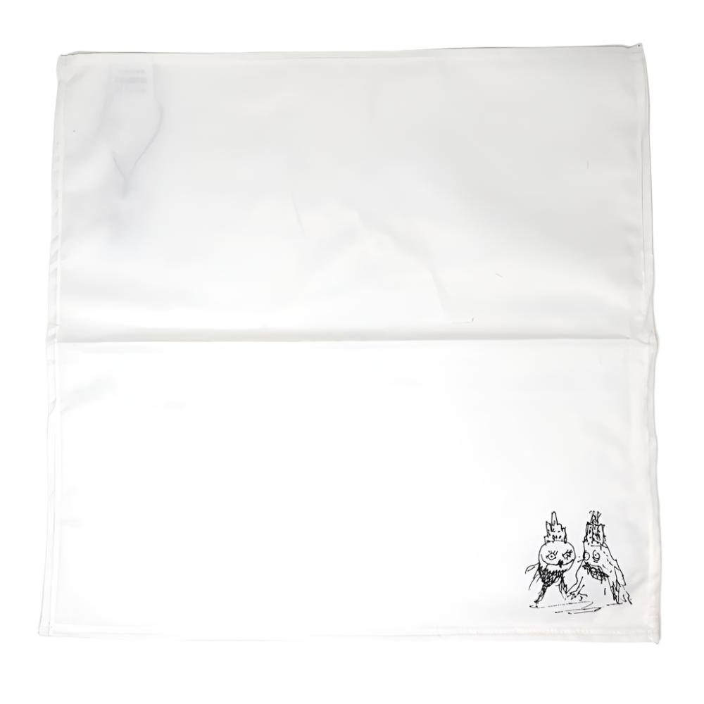 White linen napkin with a Tim Burton illustration in the bottom right corner