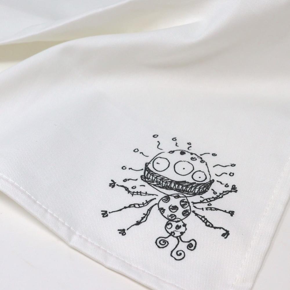 Tim Burton alien illustration white linen napkin close-up