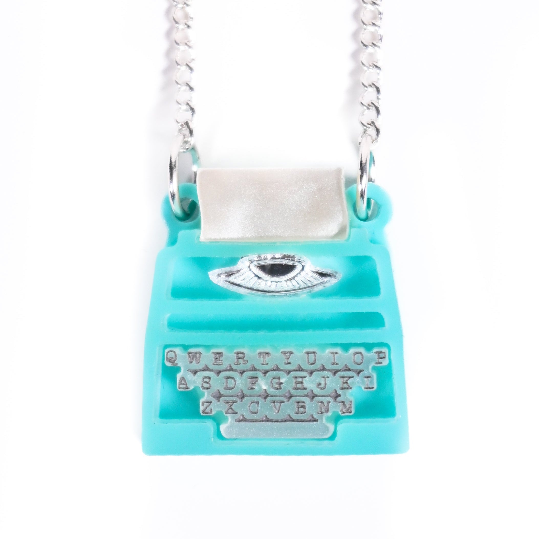 Turquoise typewriter necklace with silver chain on a white background