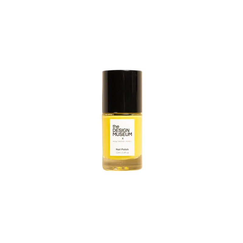 A small glass bottle of nail polish with a black cap and a white label reading 'THE DESIGN MASCOT' and 'Nail Polish', filled with yellow polish, centered on a warm off-white background.