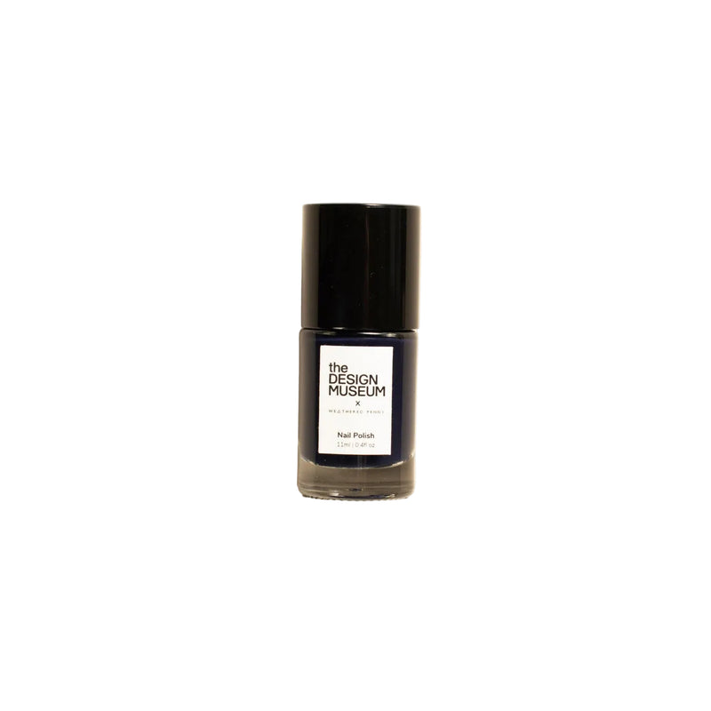 A bottle of nail polish from The Design Museum in 'Nip Pink' on a warm cream background.